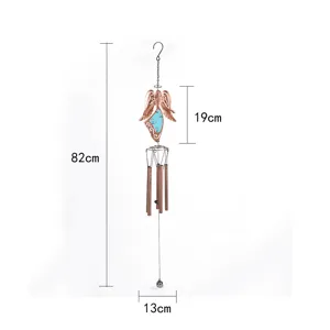 Metal angel wind chime detail view, garden hanging ornament with luminous sheet and iron tubes.