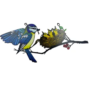 Detailed view of the colorful metal bird hanging ornament, showing feeding scene, window decor.