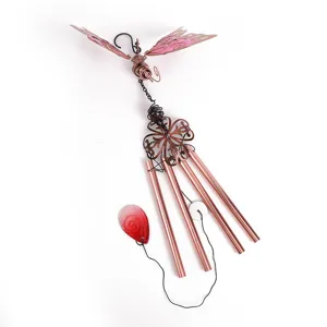 Metal butterfly wind chime with copper tubes and red glass pendant for outdoor garden decor.