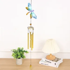 Detailed view of the colorful glass painted dragonfly wind chime with golden metal tubes.