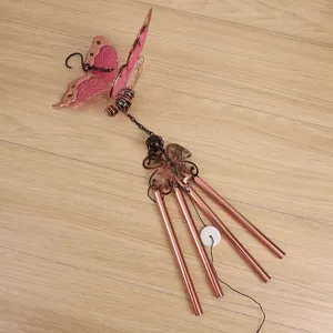 Detailed view of luminous butterfly wind chime with pink acrylic and metal tubes hanging decor.