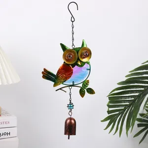 Detailed close-up shot of colorful metal glass owl wind chime garden hanging ornament.