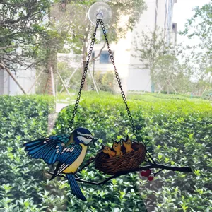 Detailed view of colorful metal bird suncatcher hanging on window with suction cup.
