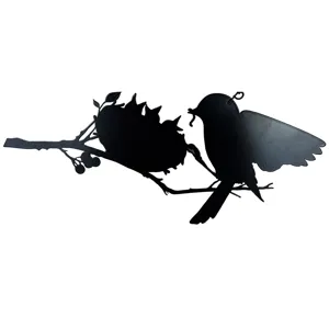 Close-up detail of the black metal bird feeding silhouette hanging decoration, elegant art.