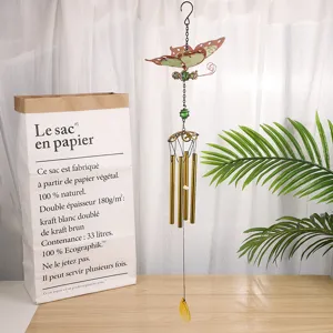 Detailed view of butterfly wind chime with metal tubes and acrylic wings for home decor.