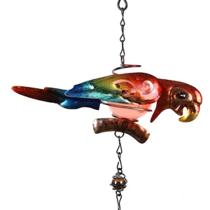 Gros plan de carillon a vent perroquet en metal colore pour decoration de jardin.