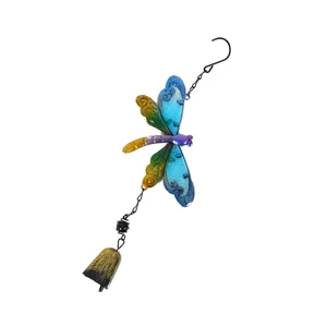 Close-up detail of colorful metal dragonfly wind chime wing texture and hanging bell design.