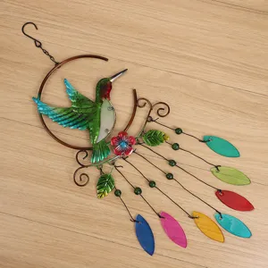 Detailed view of metal hummingbird wind chime with colorful glass leaves and beads.