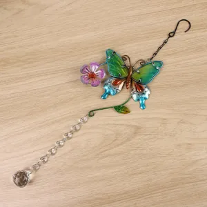 Dettaglio ornamento sospeso acchiappasole in cristallo con farfalla e sfera di cristallo.