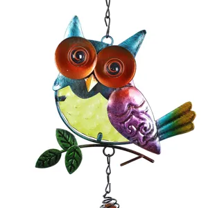 Close-up detail of the colorful iron glass owl wind chime hanging decor for garden yard.