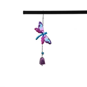 Metal dragonfly wind chime detail shot, vibrant blue and purple painted glass hanging bell ornament.