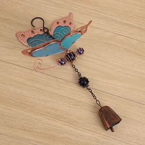 Butterfly metal wind chime pendant with blue acrylic wings and rustic bell for home decor.