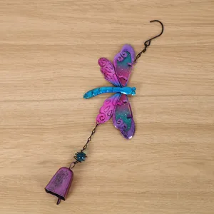 Metal dragonfly wind chime detail shot, exquisite painted craft for home decoration display.