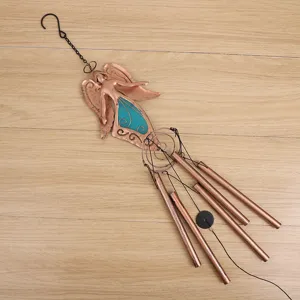 Bronze metal fairy wind chime detail, hanging ornament for garden and patio decoration.