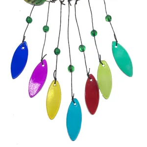 Colorful glass leaf wind chime detail shot, vibrant hanging decor for home and garden.