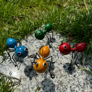 Detailed view of colorful metal ant figurines, perfect for outdoor garden and home decoration.