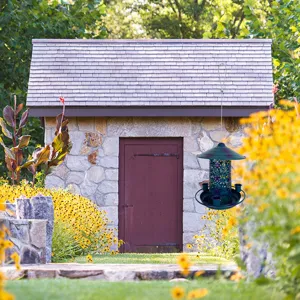 Metal hanging bird feeder detail with intricate cutout design for outdoor garden decoration.