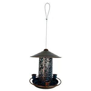 Close-up detail shot of hanging metal bird feeder, outdoor iron craft garden decor.