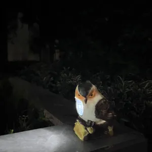 Resin bird solar light outdoor garden landscape decorative light detail view showing illumination.