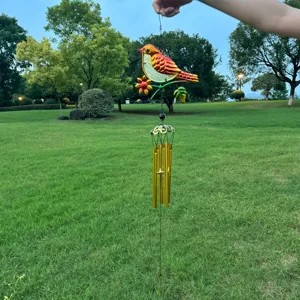 Metal bird wind chime detail shot, colorful painted glass hanging ornament for garden balcony decor.