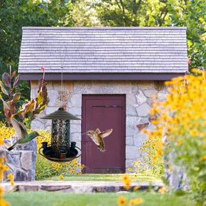 Outdoor metal bird feeder detail showcasing hollow iron art design and garden hanging setup.