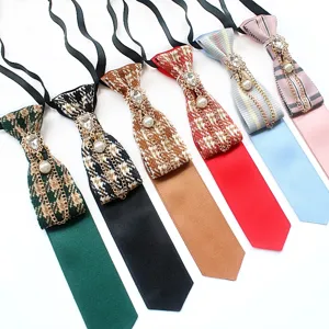 Collegiate style pre-tied necktie with retro rhinestones, pearls and chain accessories.
