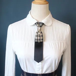 College style pre-tied necktie with houndstooth pattern, rhinestones, pearl and chain details.