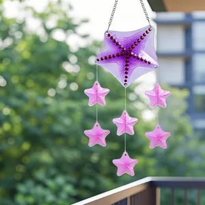 Hanging glass starfish wind chime detail, vibrant purple and pink ocean decor for home garden.
