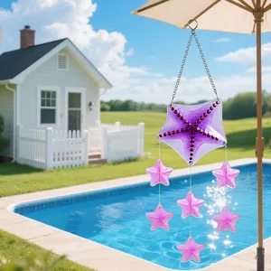 Close-up detail of the purple starfish glass wind chime hanging outdoors near a sunny pool.
