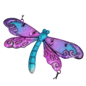 Metal dragonfly craft detail with blue purple glass wings, hanging ornament closeup view.