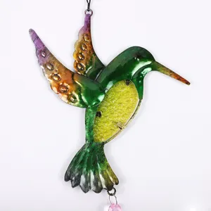 Metal hummingbird suncatcher detail, colorful hanging crystal pendant for garden decor.