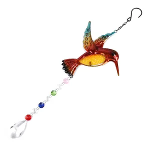Closeup of the colorful metal hummingbird suncatcher showing crystal beads and pendant details.