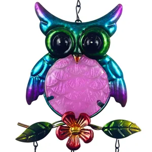 Colorful metal owl hanging wind chime detail with pink textured glass belly and floral accents.