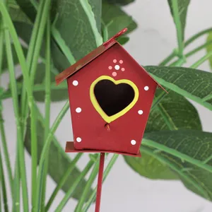 Metal birdhouse garden stake with heart-shaped hole and white dots, perfect for potted plant decor.