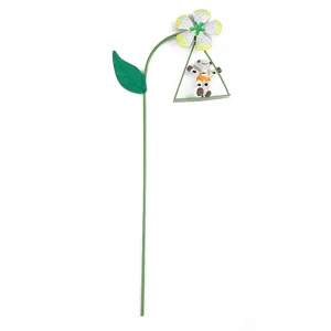Metal garden flower stake detail view, showing the swinging animal and flower design clearly.