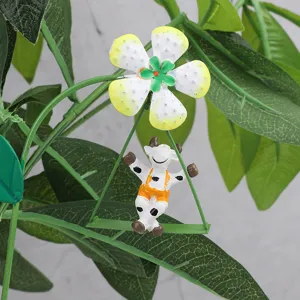 Metal flower garden stake with cute swinging cow decor, perfect for potted plants and landscaping.