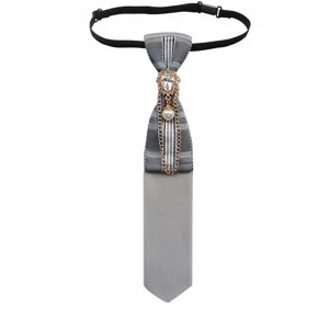 Close-up of British plaid pre-tied tie featuring a delicate crystal pearl chain brooch.
