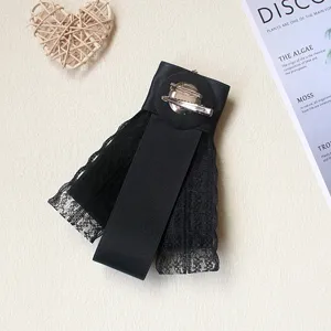 Spilla con fiocco in pizzo nero vista posteriore dettaglio accessorio stile retro.