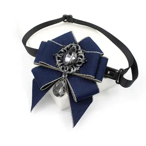 Dark blue ribbon bow tie detail featuring vintage silver filigree and grey crystal pendant.