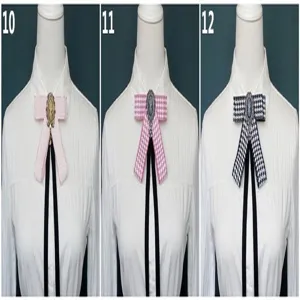 Detailed view of pre-tied bow ties with vintage cameo centers for school uniforms.