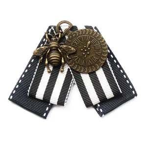 Vintage black and white striped ribbon brooch with bronze bee and clock charm for women.
