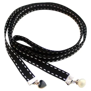 Black ribbon necktie with white stitching, pearl and heart charms for women fashion.