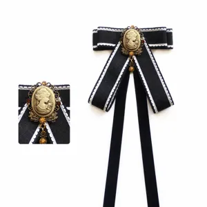 Classic gothic college style ribbon bow tie with vintage cameo brooch, 28cm length.