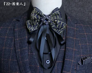 Exquisite vintage men's bow tie with Egyptian style figure pattern and crystal centerpiece.