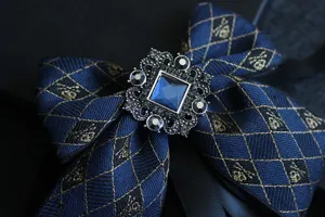 Men's luxury vintage bow tie with crystal rhinestone brooch, elegant dark blue fabric.