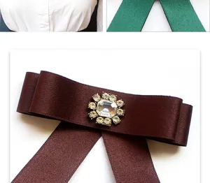 Detailed view of brown satin bow tie with rhinestone crystal buckle for JK uniform shirts.