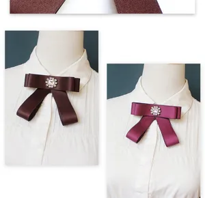 Detailed view of JK uniform bow tie collar ribbon with rhinestone center for women shirts.