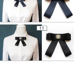 Black satin ribbon bow brooch featuring crystal rhinestone for JK uniform shirt detail.