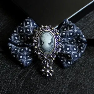 Vintage dark blue bow brooch pin with cameo portrait and dazzling rhinestones for suits