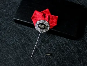 Close-up detail of the red fabric lapel pin featuring a vintage silver filigree design and dark gem.